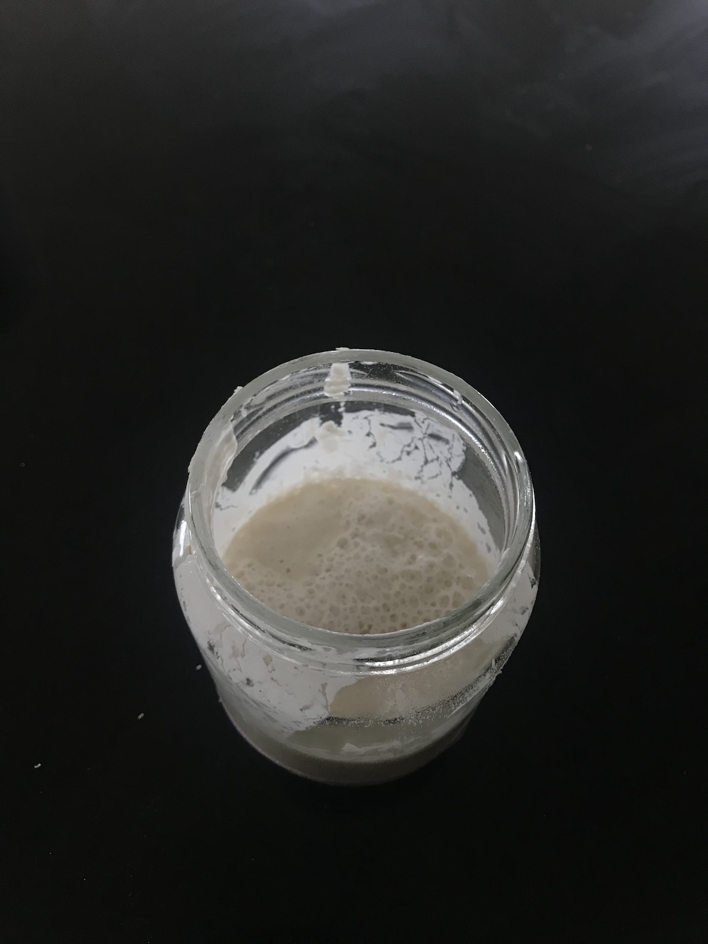 a sourdough starter in a jar, very bubbly