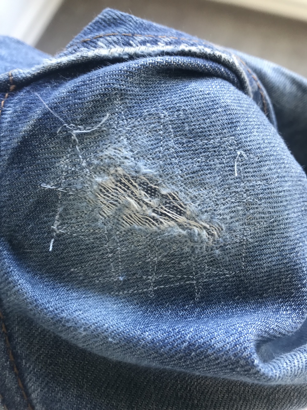 a patched hole in some jeans