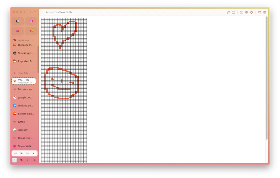 a grid with red cells filled in the shape of a face and a heart